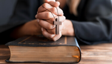 Person Praying With Cross And Holy Bookst Pauls Confirmation